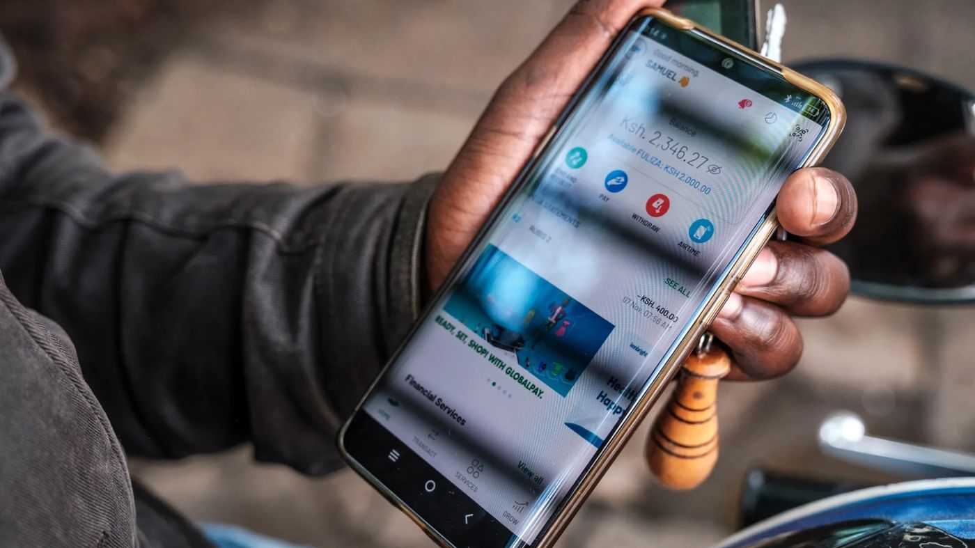 A phone showing an M-Pesa payment screen