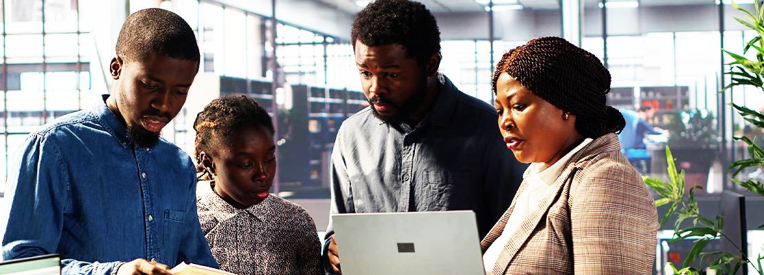 The Biztech Links team working together on a laptop